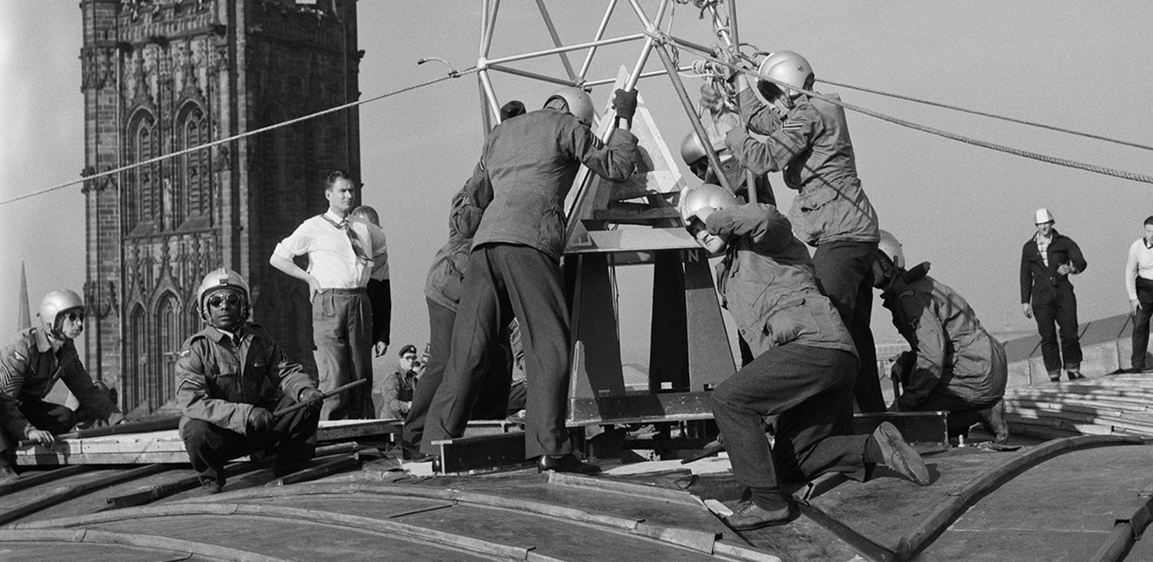 Historic England: RAF aircrew on the roof of Coventry Cathedral. Historic England Archive.